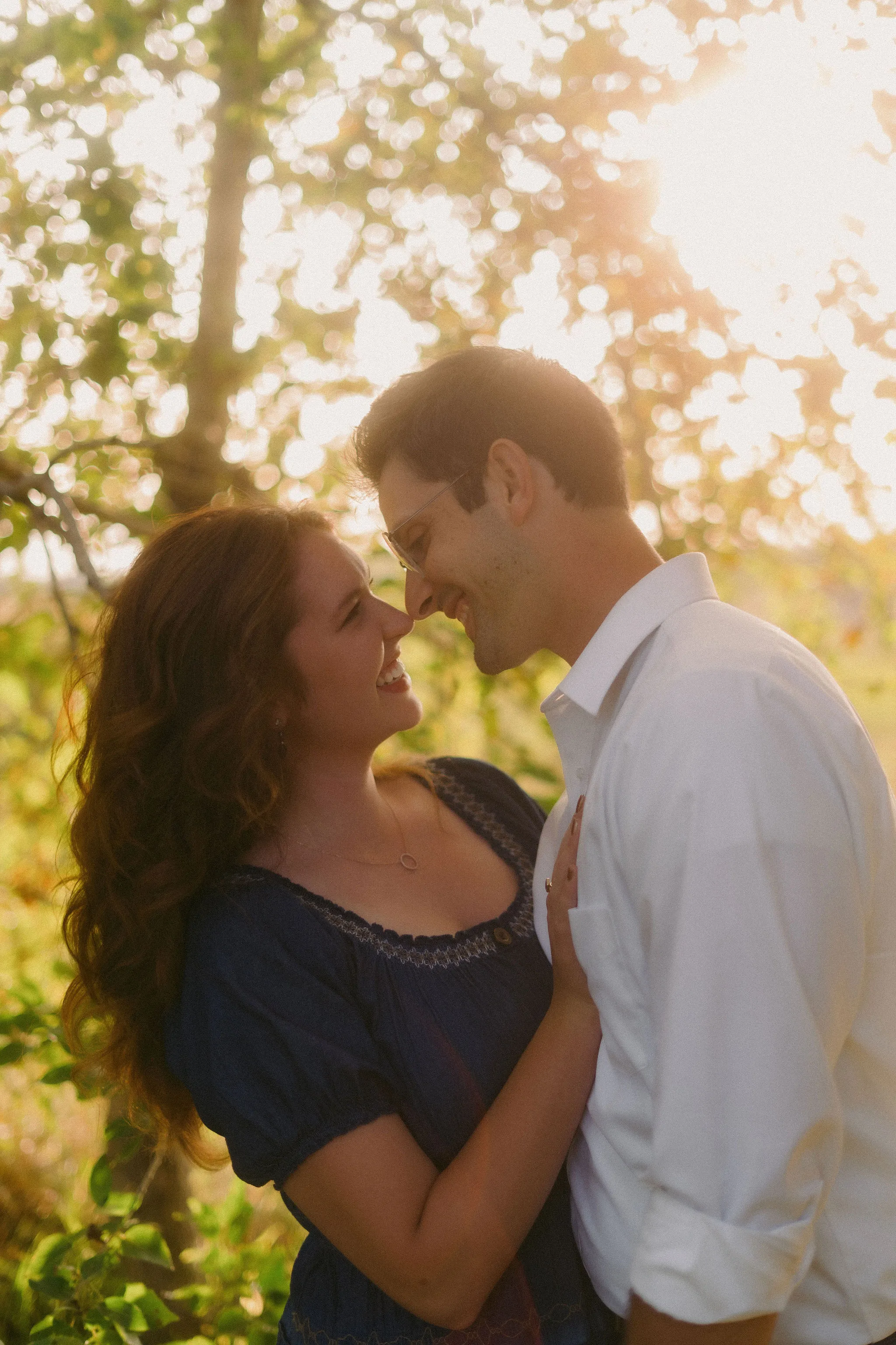 Ethan and June smiling together in warm sunlight.